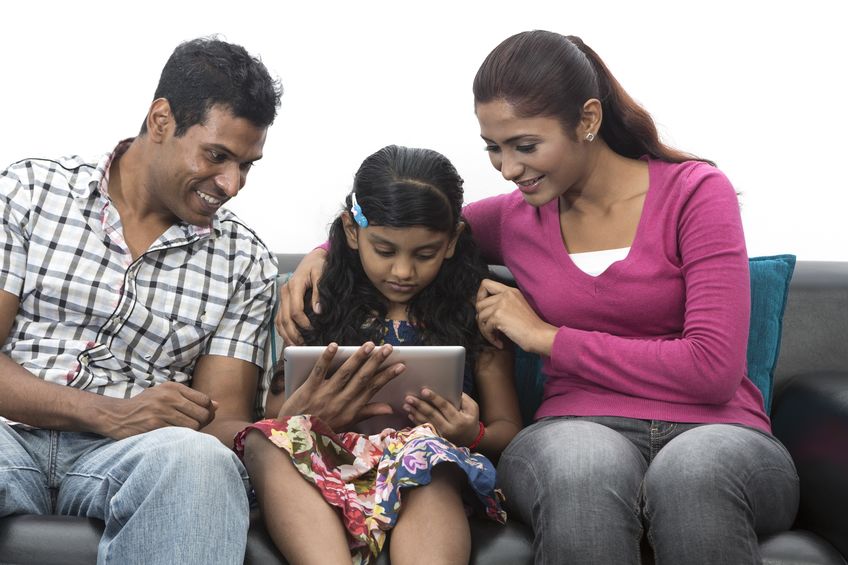 Father Mother helping daughter to learn mobile apps