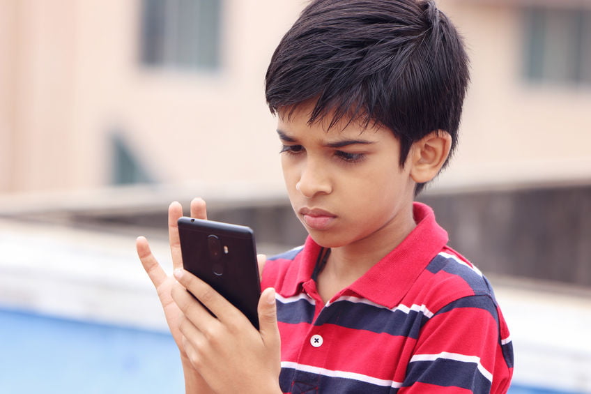 Addicted Indian Child playing games in phone